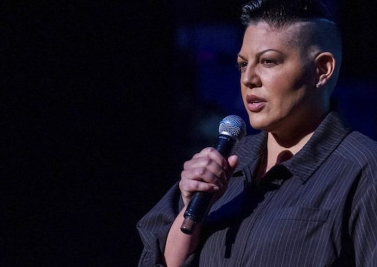 Portrait of Sara Ramirez, a talented actor and LGBTQ+ advocate, smiling and looking into the camera