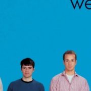 Weezer rocks 50s style in a vibrant concert scene, channeling the spirit of Buddy Holly Weezer